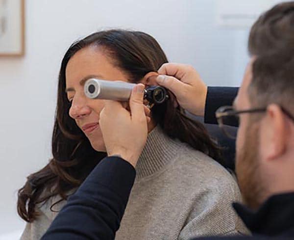 Lady has here examined to ensure that it is safe for microsuction, at a London clinic.